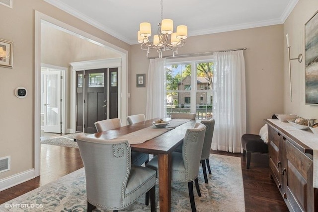 dining area with ornamental molding, dark wood-type flooring, and a notable chandelier