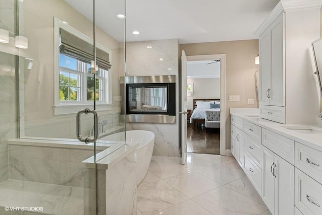 bathroom featuring independent shower and bath, a multi sided fireplace, and vanity