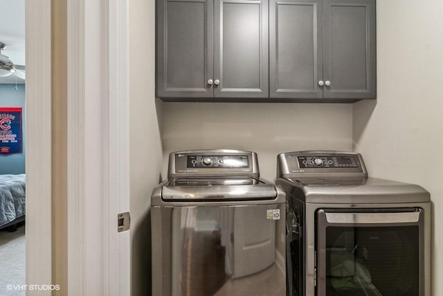 laundry area featuring cabinets, washing machine and clothes dryer, and ceiling fan