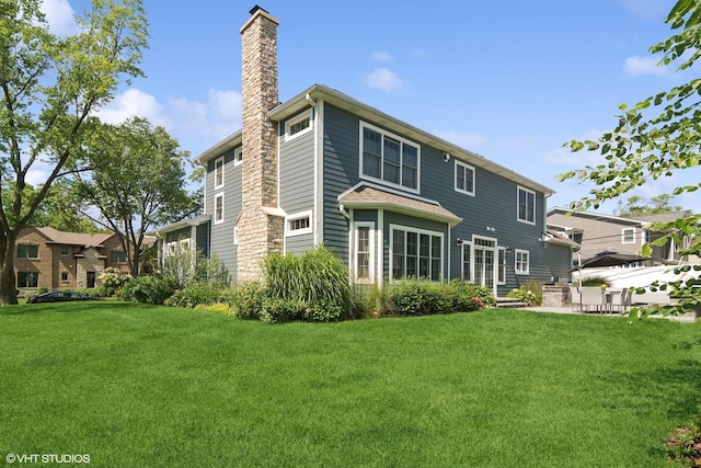 back of house with a yard and a patio area