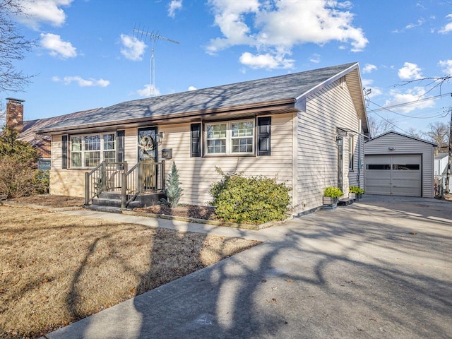 view of front of home with a garage and an outdoor structure