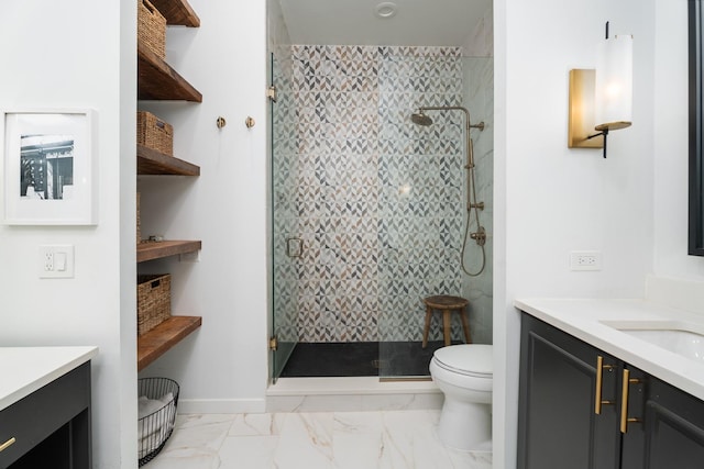 bathroom featuring a shower with door, vanity, and toilet