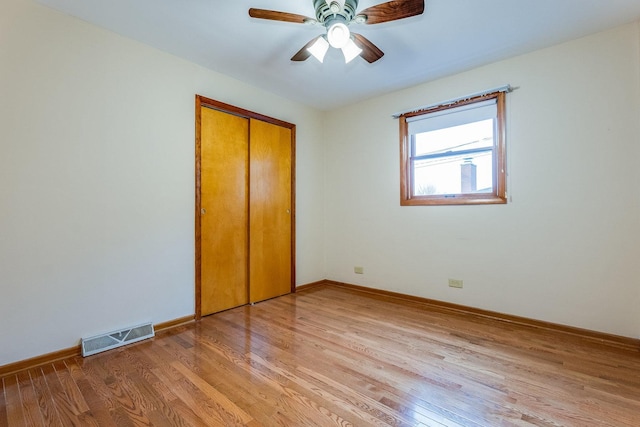 unfurnished bedroom with a closet, ceiling fan, and light wood-type flooring