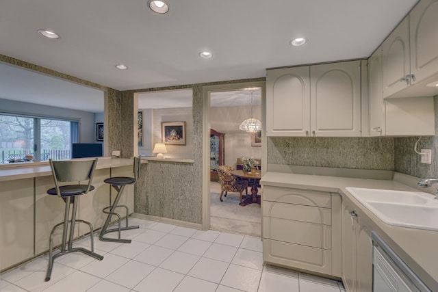 2 Oak Brook Club Dr Unit B209, Oak Brook, IL 60523 - kitchen with light tile patterned flooring, recessed lighting, light countertops, a sink, and dishwasher
