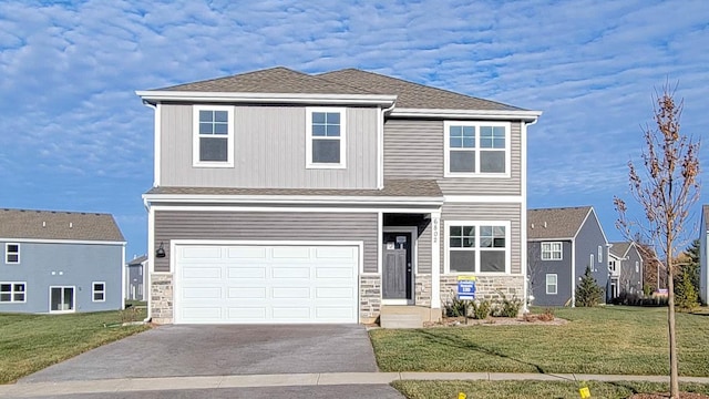 front facade featuring a garage and a front yard