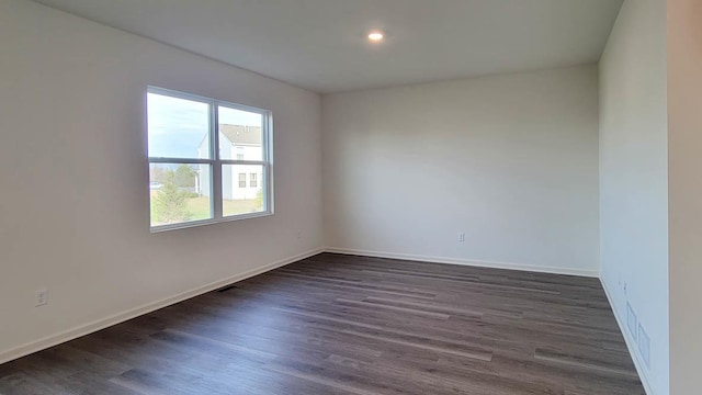 spare room featuring dark hardwood / wood-style floors