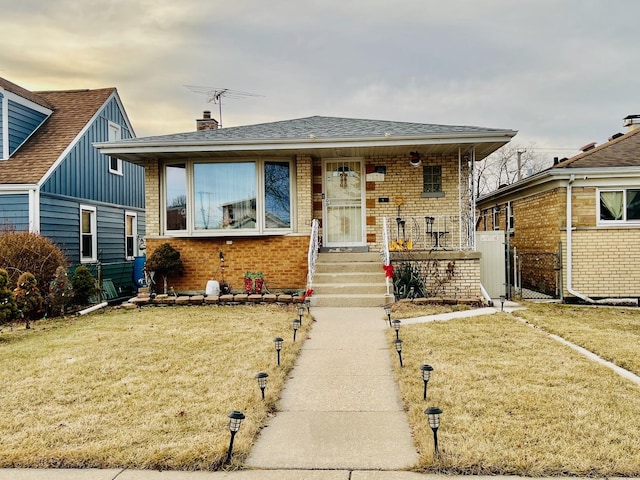 bungalow-style house featuring a front yard