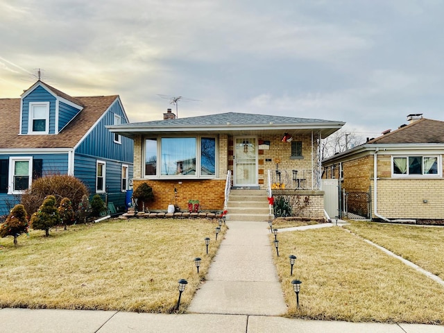 bungalow-style house with a front yard