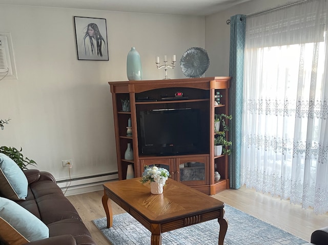 living room with light hardwood / wood-style flooring and a baseboard radiator