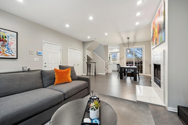 living room with a premium fireplace and dark hardwood / wood-style flooring