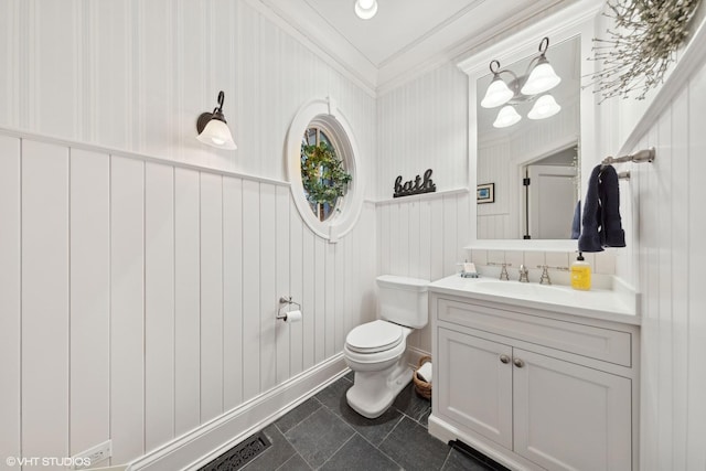 bathroom with vanity, ornamental molding, and toilet