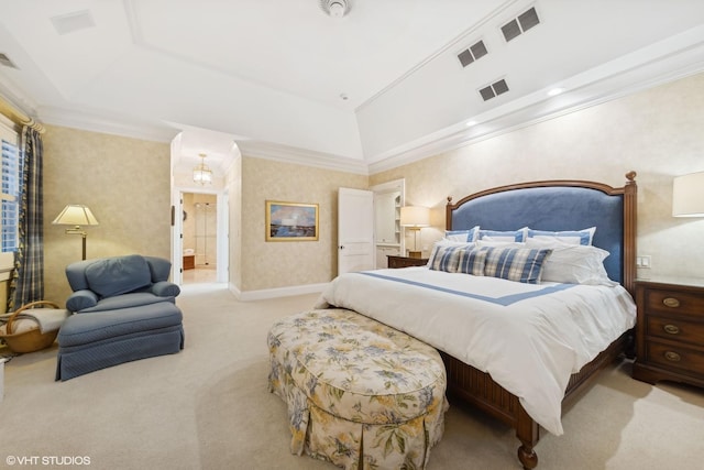 bedroom with crown molding, light colored carpet, and ensuite bath