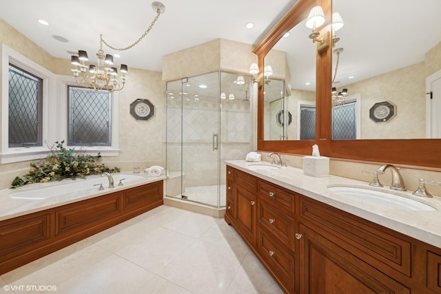 bathroom featuring shower with separate bathtub, a chandelier, vanity, and tile patterned floors