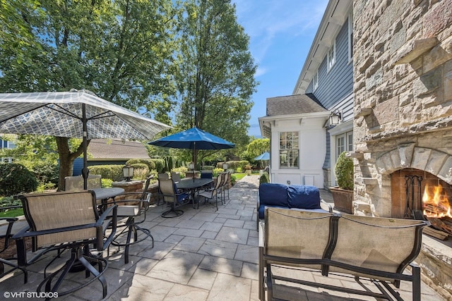 view of patio / terrace featuring an outdoor stone fireplace