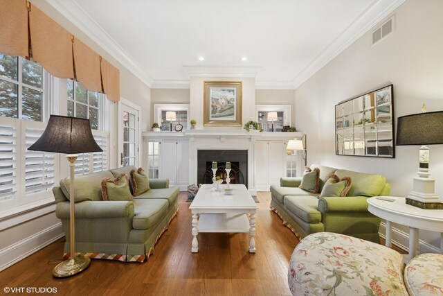 living room with crown molding and light hardwood / wood-style floors