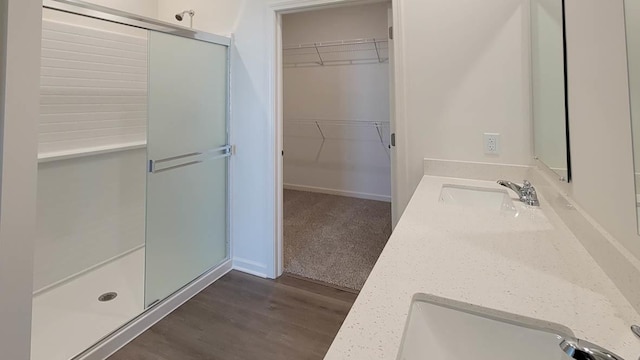 bathroom with vanity, hardwood / wood-style floors, and walk in shower