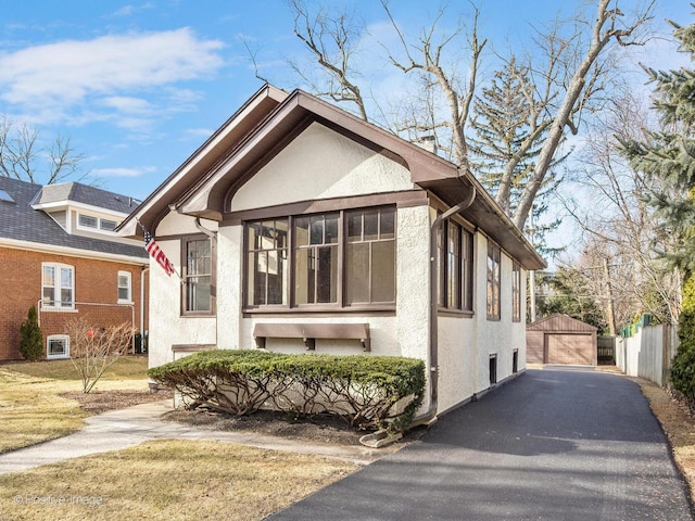 view of front of house with a garage and an outdoor structure