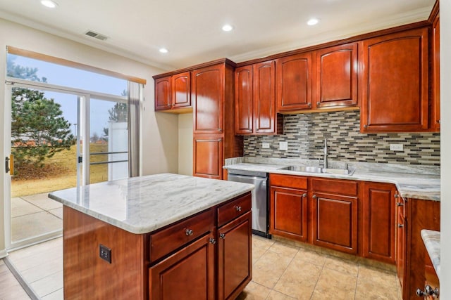 kitchen featuring visible vents, dark brown cabinets, light stone counters, stainless steel dishwasher, and a sink