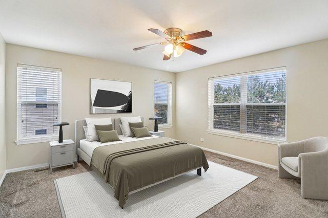 bedroom featuring multiple windows, carpet, and baseboards