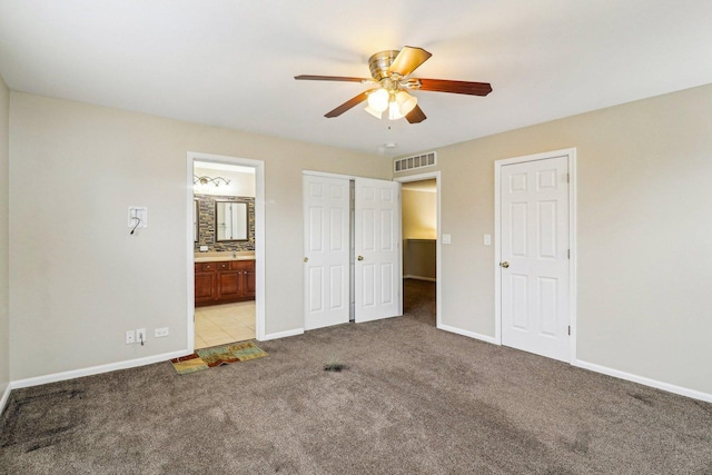 unfurnished bedroom with visible vents, baseboards, light colored carpet, and connected bathroom