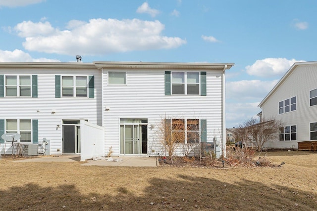 rear view of property featuring a patio area and a lawn