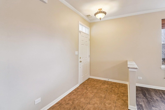 tiled entrance foyer with visible vents, baseboards, and ornamental molding