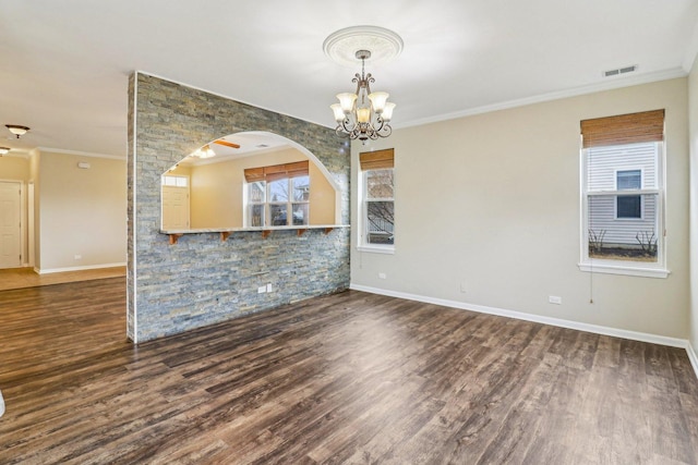 interior space featuring visible vents, wood finished floors, and ornamental molding