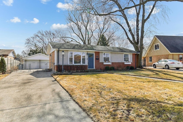 view of front of property featuring a front lawn, fence, an outdoor structure, and brick siding