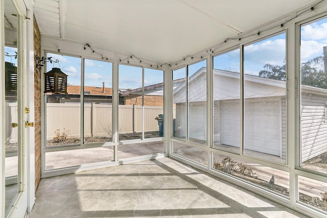 unfurnished sunroom featuring lofted ceiling