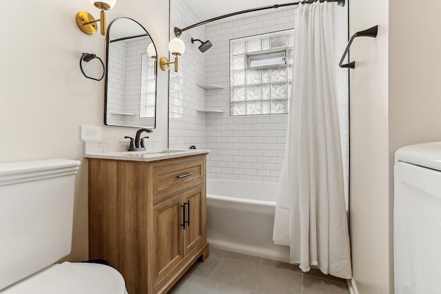 bathroom featuring toilet, washer / clothes dryer, shower / bathtub combination with curtain, tile patterned flooring, and vanity