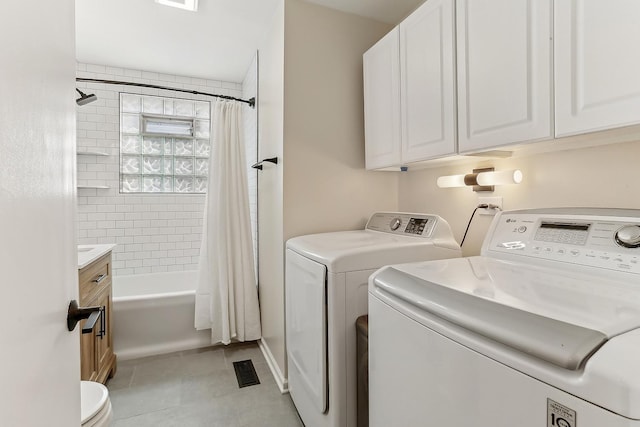 laundry area with laundry area, light tile patterned floors, visible vents, and washer and clothes dryer