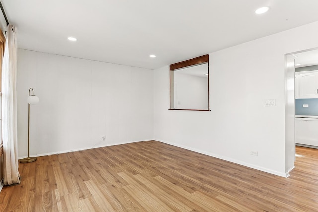 unfurnished room featuring baseboards, recessed lighting, and light wood-style floors