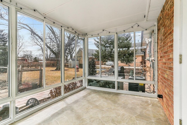 unfurnished sunroom with a wealth of natural light and vaulted ceiling