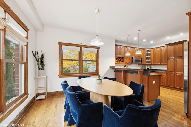 dining space featuring light wood-type flooring