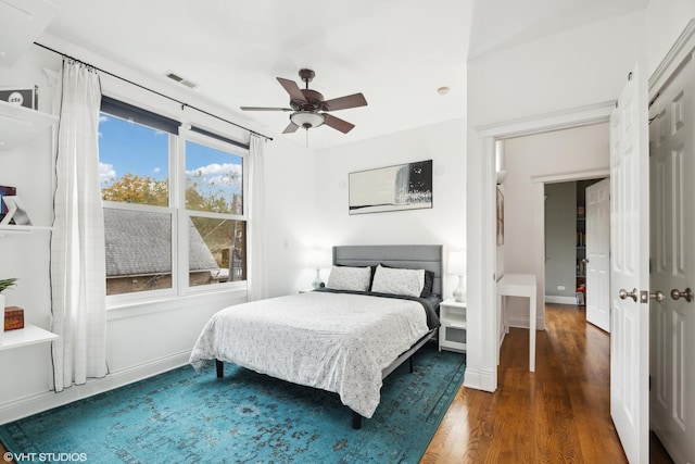 bedroom with dark wood-type flooring and ceiling fan