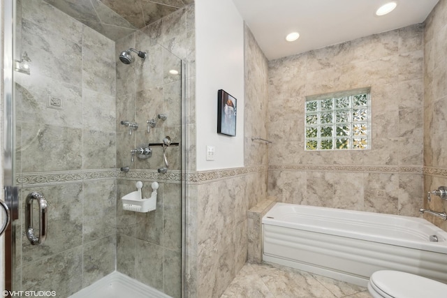 bathroom featuring shower with separate bathtub, tile walls, and toilet