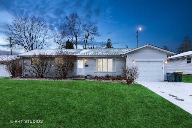 ranch-style home with a garage and a front yard