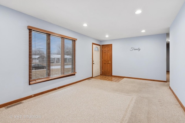 unfurnished room with light carpet