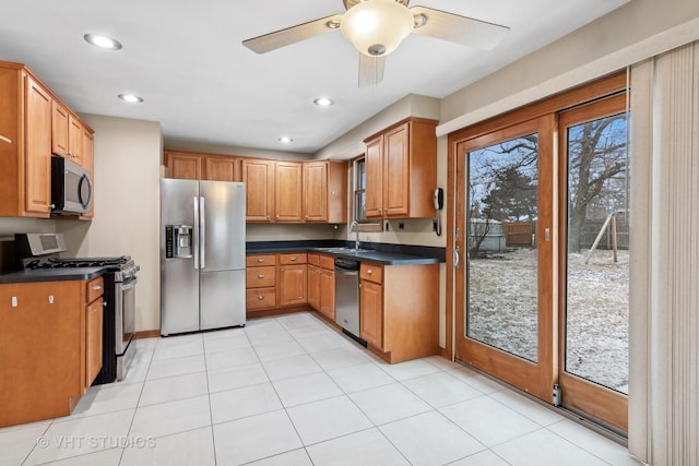 kitchen featuring ceiling fan, appliances with stainless steel finishes, sink, and light tile patterned floors