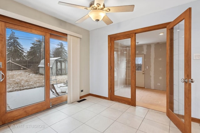 doorway to outside with french doors, a healthy amount of sunlight, and light tile patterned floors