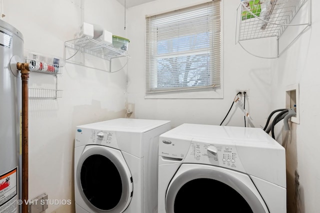 washroom featuring water heater and washer and dryer