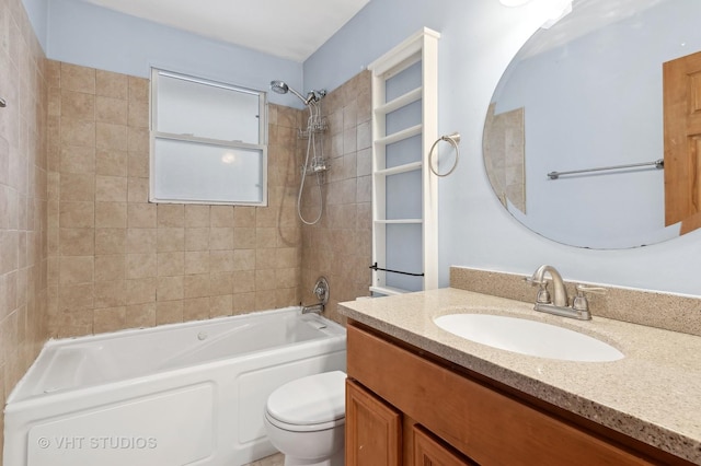 full bathroom featuring tiled shower / bath combo, vanity, and toilet