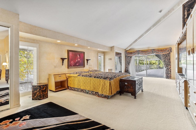 carpeted bedroom featuring access to exterior, vaulted ceiling, and multiple windows