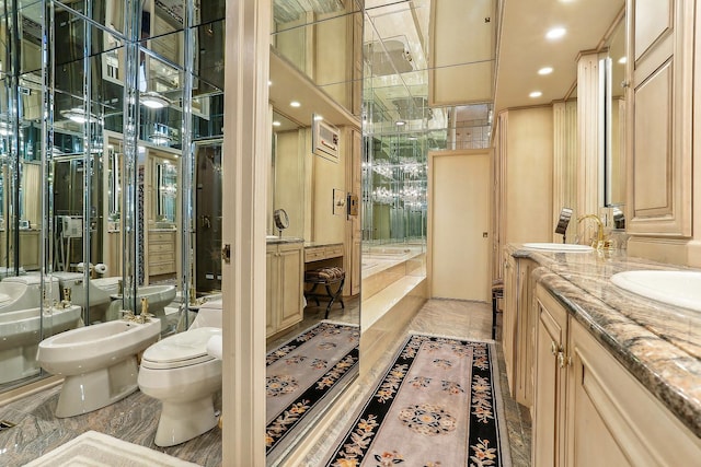 bathroom featuring a bidet, vanity, and toilet