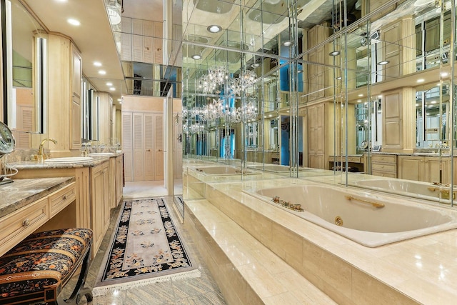 bathroom with a relaxing tiled tub and vanity