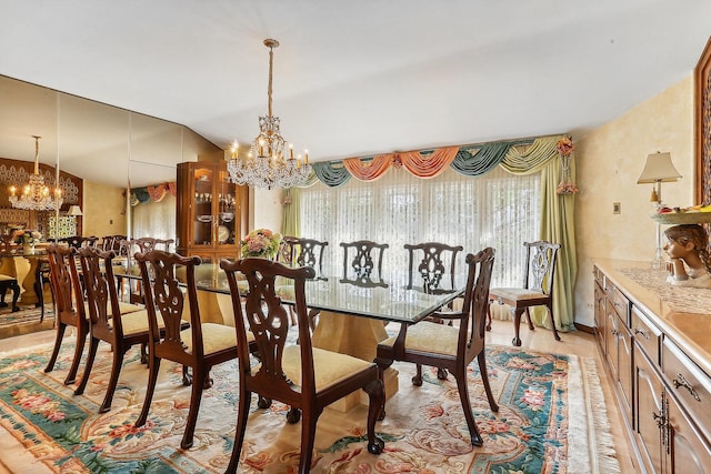 dining space featuring a notable chandelier and vaulted ceiling