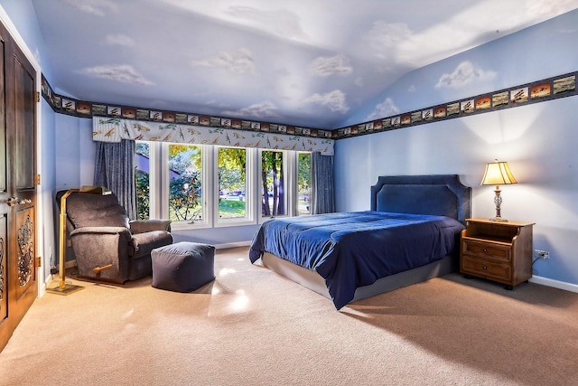 bedroom with vaulted ceiling and carpet flooring