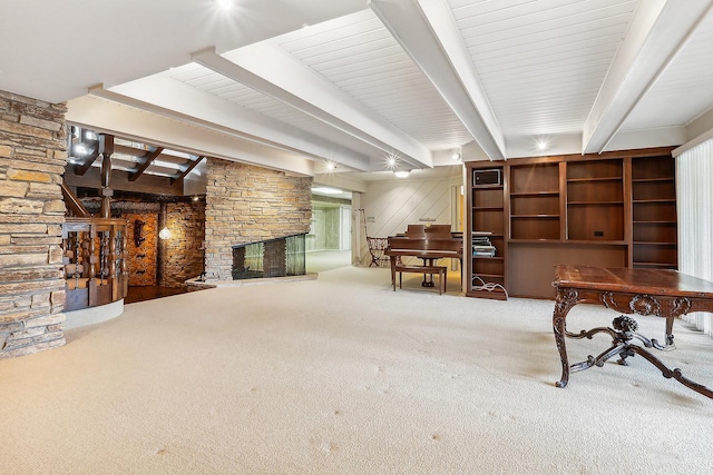 misc room with beam ceiling, a fireplace, and carpet flooring