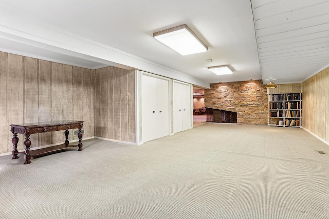 basement with carpet flooring and wood walls