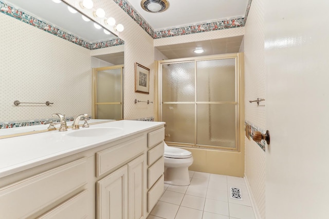 full bathroom with vanity, tile patterned floors, shower / bath combination with glass door, and toilet